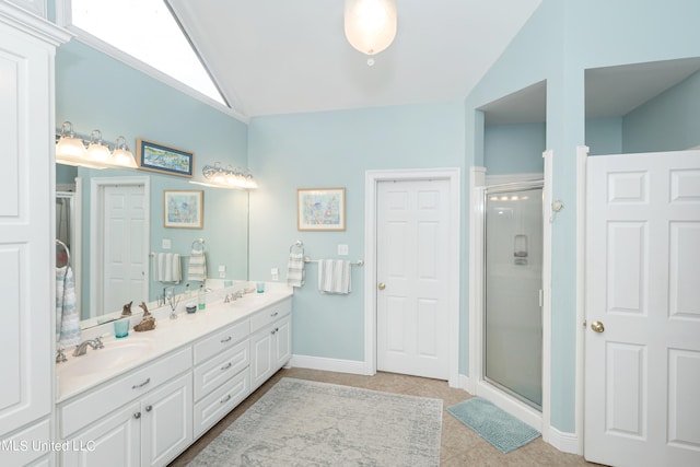 bathroom with vanity, vaulted ceiling, and a shower with shower door