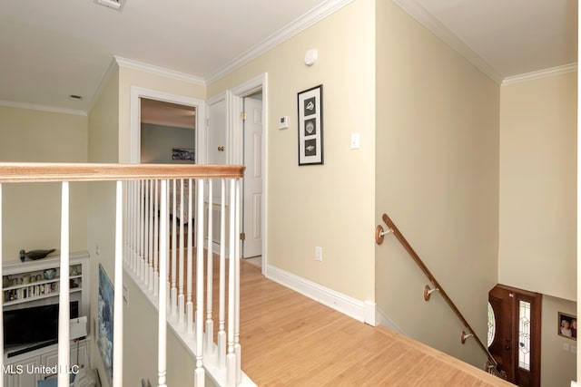 hallway with ornamental molding and hardwood / wood-style floors