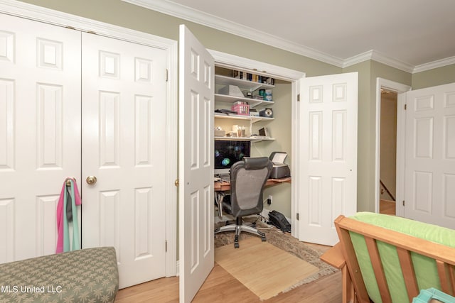 home office with light hardwood / wood-style flooring and crown molding