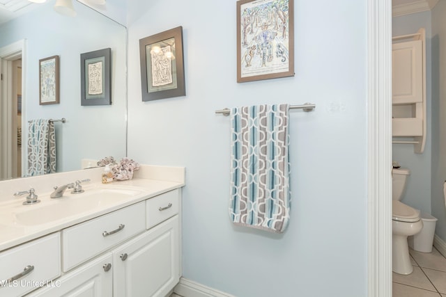 bathroom with toilet, vanity, and tile patterned floors