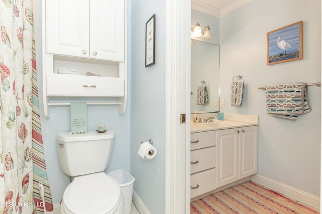 bathroom featuring vanity, toilet, and crown molding