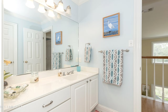 bathroom featuring vanity, hardwood / wood-style flooring, and ornamental molding