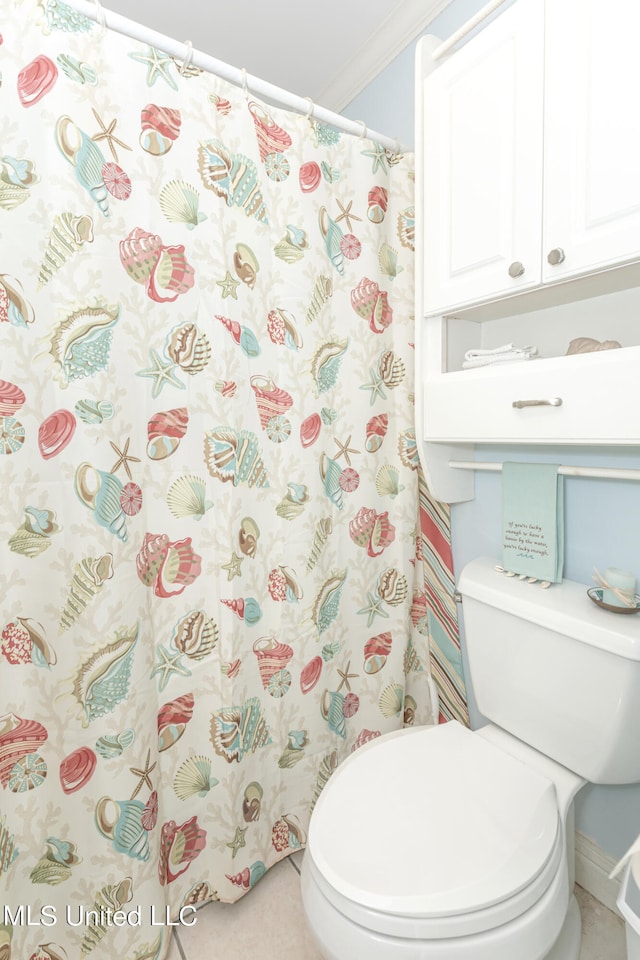 bathroom featuring toilet, ornamental molding, and walk in shower