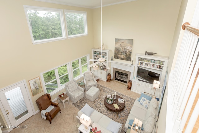 living room with a healthy amount of sunlight, ornamental molding, and light tile patterned floors