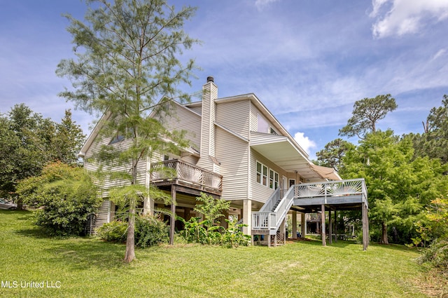 back of house with a deck and a lawn