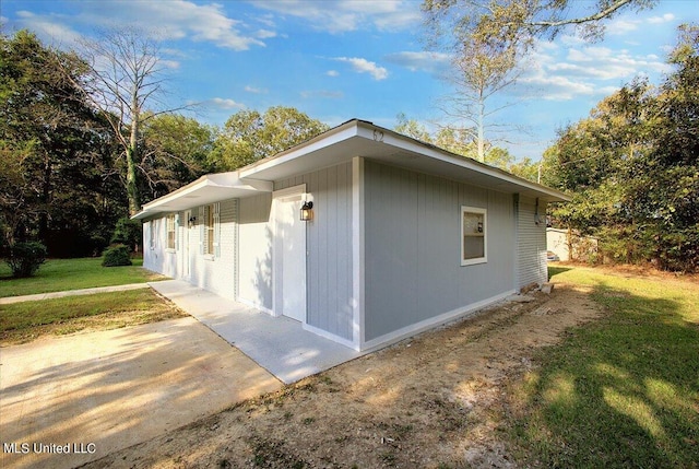 view of side of home featuring a yard