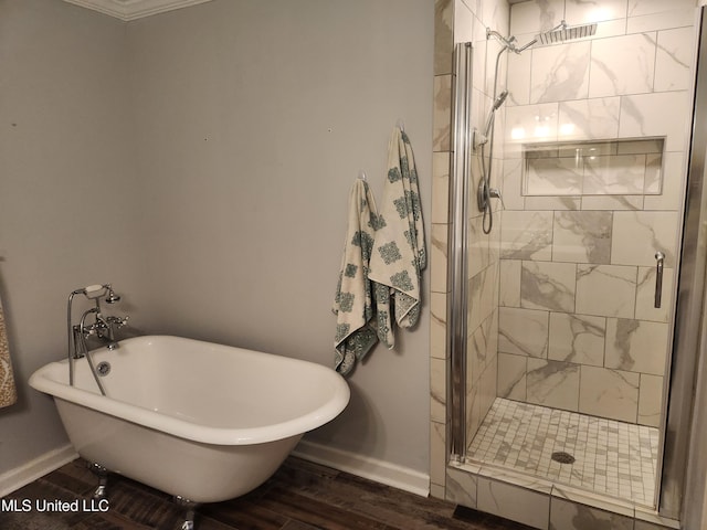 bathroom with wood-type flooring and shower with separate bathtub