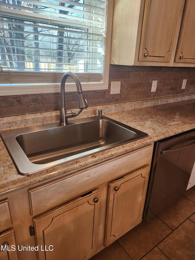 kitchen featuring light brown cabinetry, tasteful backsplash, dishwasher, sink, and tile patterned flooring