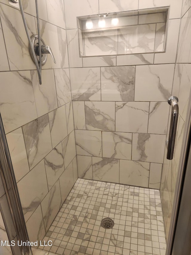 bathroom with tiled shower