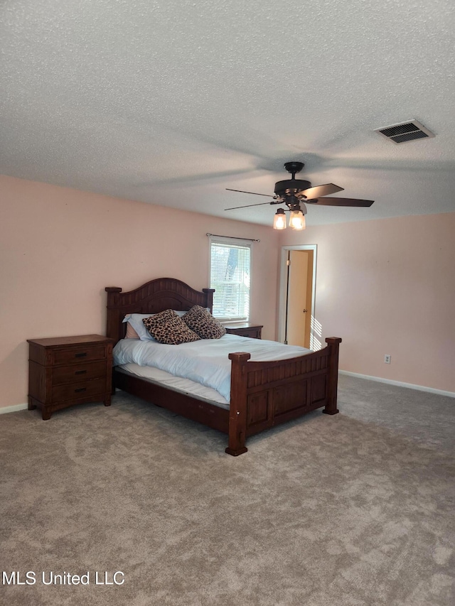 bedroom with a textured ceiling, ceiling fan, and carpet flooring