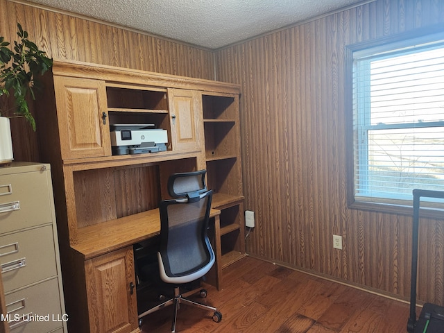 office featuring dark hardwood / wood-style flooring, a textured ceiling, and wood walls