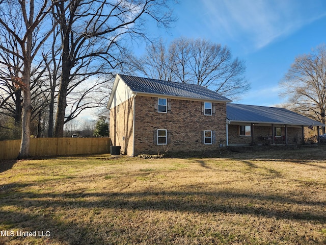 rear view of house with a lawn and central air condition unit