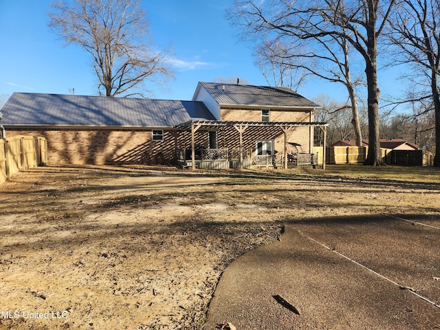 rear view of house with a pergola