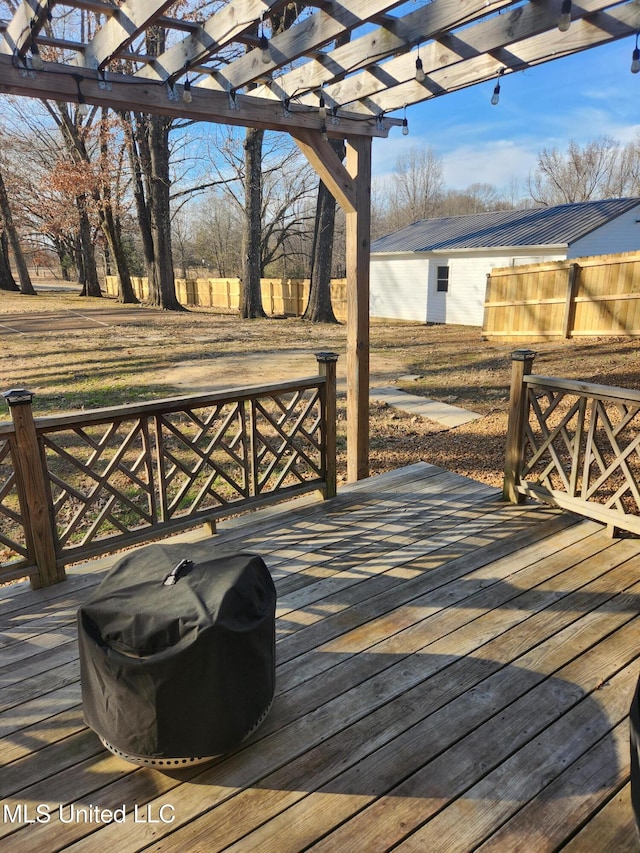 wooden deck with grilling area and a pergola