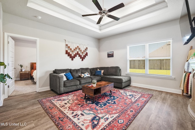 7380 Shearwater Way, Ocean Springs, MS 39564 - living area featuring a tray ceiling, wood finished floors, ceiling fan, baseboards, and crown molding