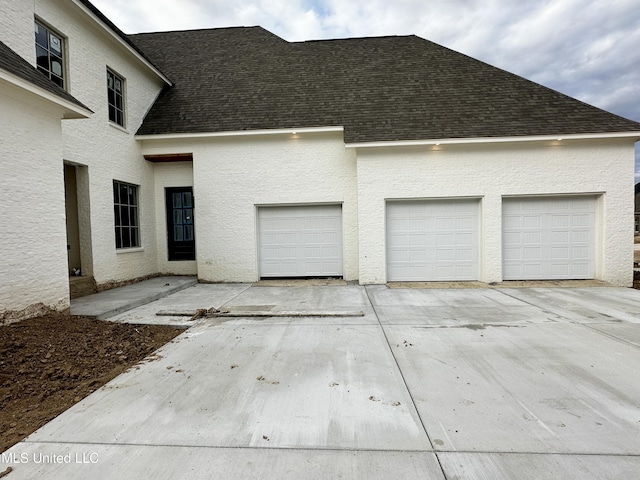 garage with concrete driveway