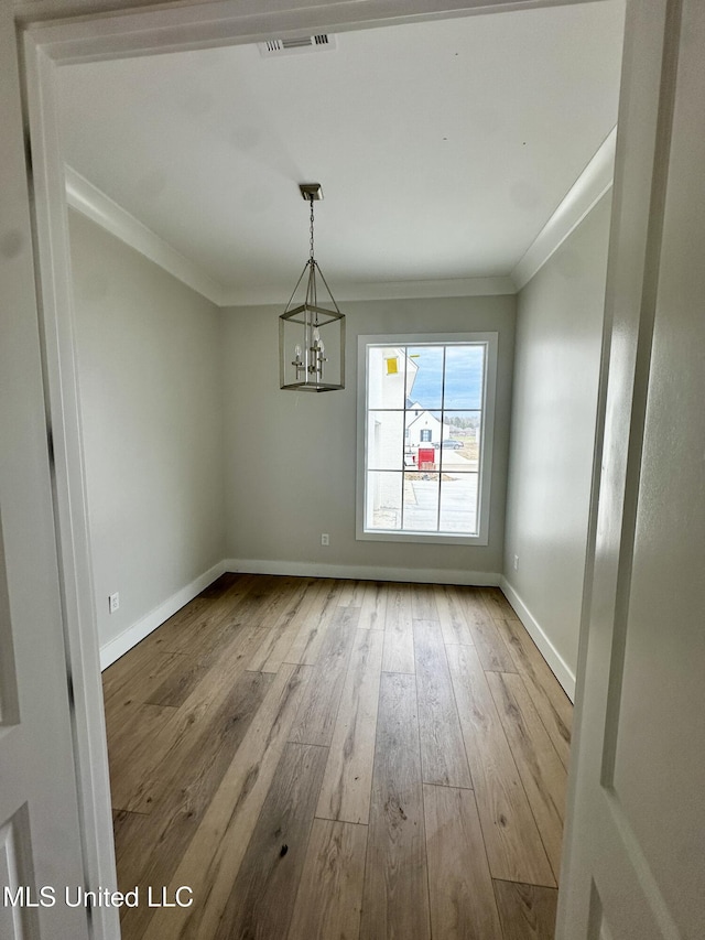 133 Genoa Dr, Madison, MS 39110 - unfurnished dining area with ornamental molding, wood-type flooring, and a chandelier