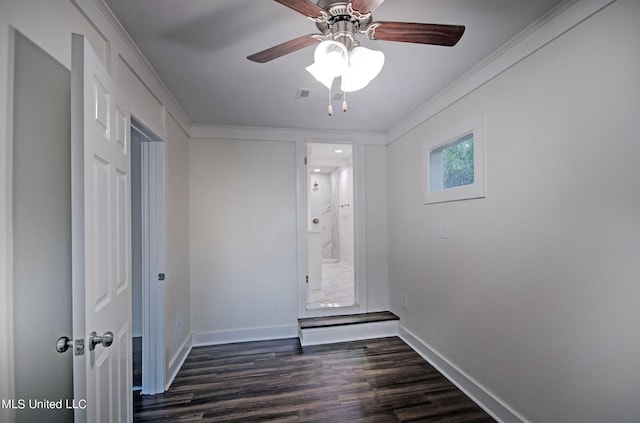 empty room with crown molding, dark hardwood / wood-style floors, and ceiling fan