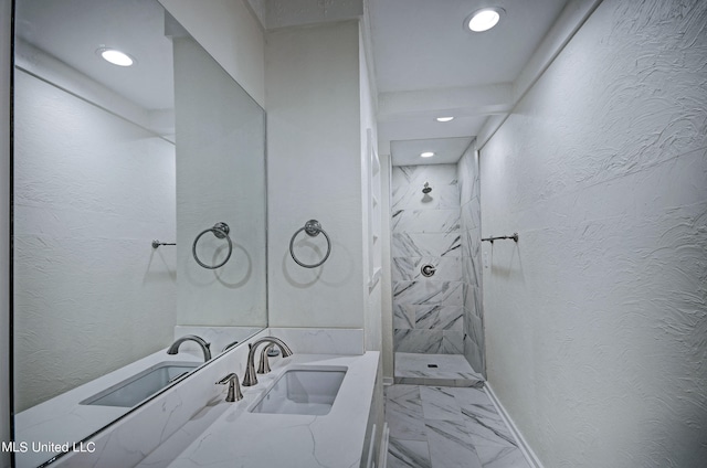 bathroom featuring vanity and tiled shower