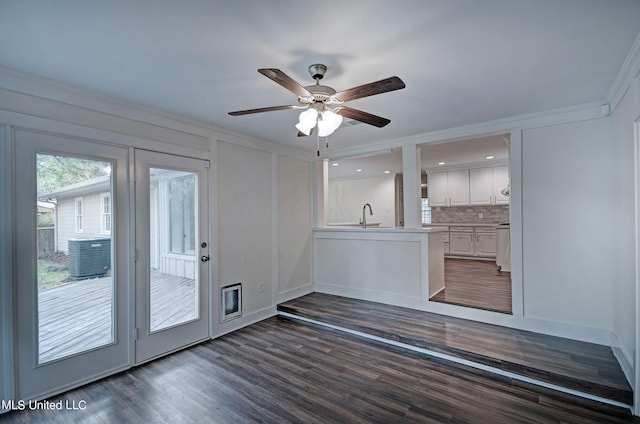 interior space with sink, dark wood-type flooring, crown molding, and ceiling fan