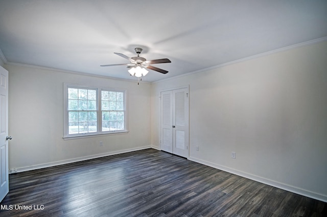 unfurnished bedroom with dark hardwood / wood-style flooring, crown molding, a closet, and ceiling fan