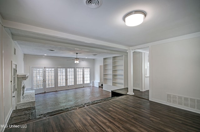 unfurnished living room featuring french doors, dark hardwood / wood-style floors, built in shelves, and ceiling fan