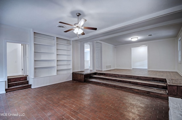 unfurnished room featuring ornamental molding, built in shelves, and ceiling fan