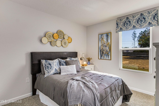 bedroom featuring carpet flooring, multiple windows, and a textured ceiling