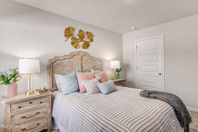 bedroom with carpet and a textured ceiling