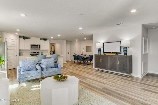 living room with light hardwood / wood-style floors