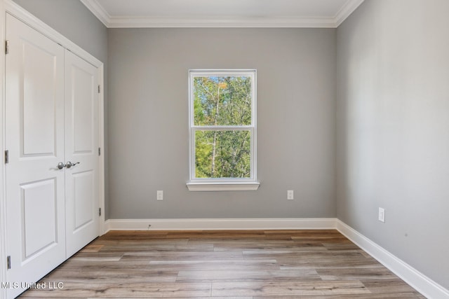 unfurnished bedroom featuring light wood-type flooring and ornamental molding