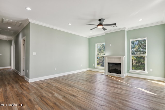 unfurnished living room with ceiling fan, plenty of natural light, crown molding, and dark hardwood / wood-style floors