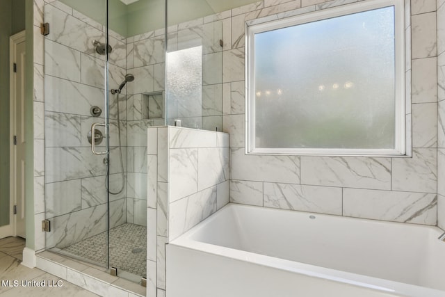 bathroom featuring tile patterned floors, separate shower and tub, and a healthy amount of sunlight