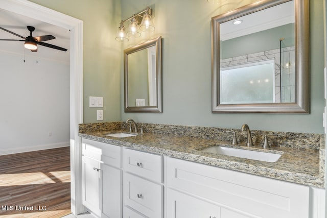 bathroom with hardwood / wood-style flooring, ceiling fan, crown molding, and vanity