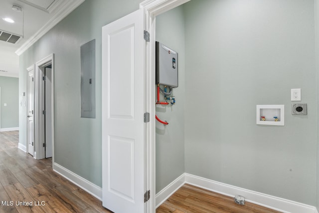 hallway with hardwood / wood-style floors, electric panel, crown molding, and water heater