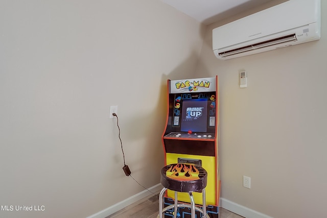 112 Vista Dr, Pass Christian, MS 39571 - game room with baseboards, a wall unit AC, and wood finished floors