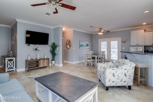 living room with ceiling fan and ornamental molding