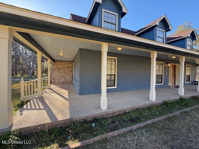 view of side of property featuring a porch