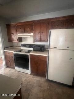 kitchen with exhaust hood and white appliances