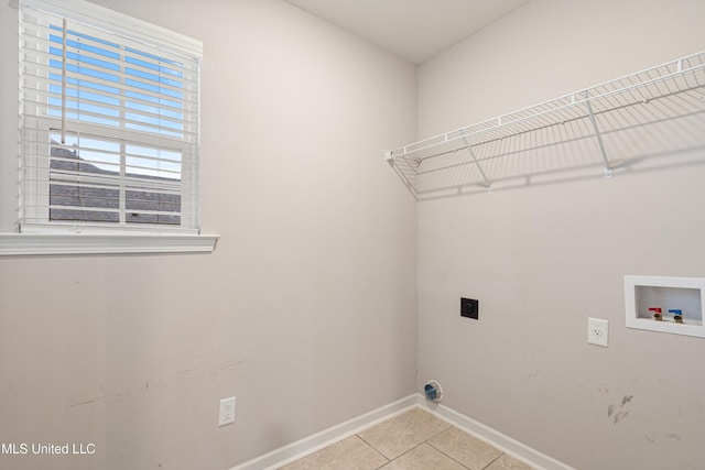 laundry room with hookup for an electric dryer, baseboards, hookup for a washing machine, and light tile patterned flooring