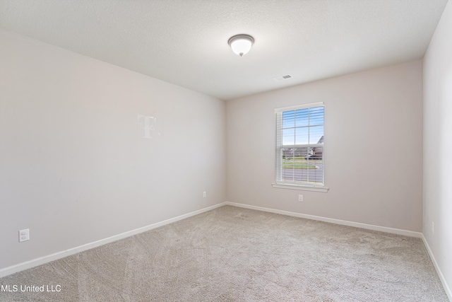 unfurnished room featuring carpet and baseboards