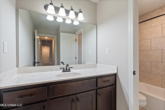 bathroom featuring vanity, toilet, and shower / bath combination