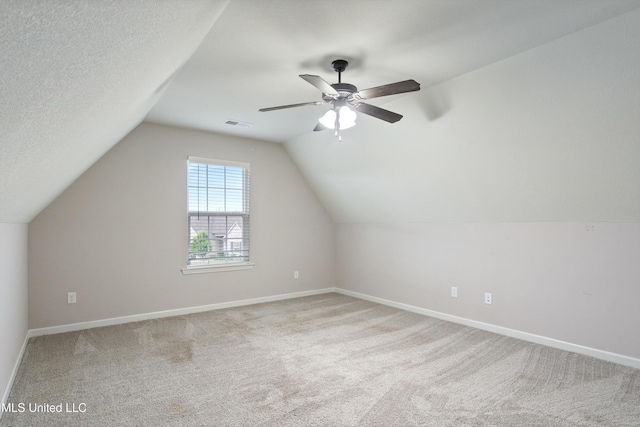 bonus room with carpet flooring, lofted ceiling, baseboards, and ceiling fan
