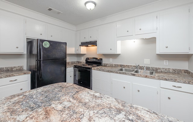 27 Wisteria Ct, Jackson, MS 39204 - kitchen with black appliances, under cabinet range hood, a sink, white cabinets, and a textured ceiling
