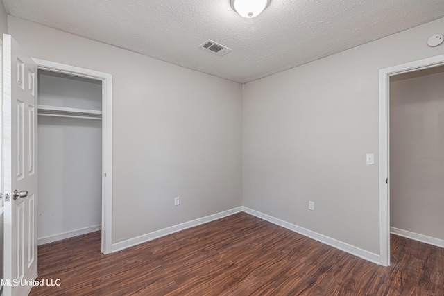 27 Wisteria Ct, Jackson, MS 39204 - unfurnished bedroom featuring wood finished floors, a closet, baseboards, and a textured ceiling