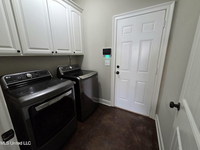 305 Flagstone Dr, Brandon, MS 39042 - laundry area with separate washer and dryer, cabinet space, and dark tile patterned flooring