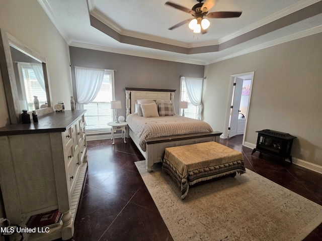 305 Flagstone Dr, Brandon, MS 39042 - bedroom with a wood stove, crown molding, a tray ceiling, ceiling fan, and dark tile patterned floors