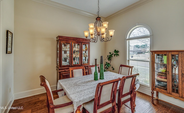 dining space with an inviting chandelier, baseboards, ornamental molding, and dark wood finished floors