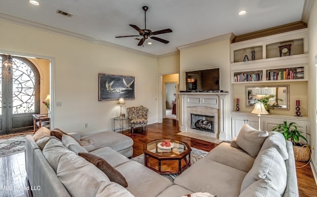 living room with french doors, a tiled fireplace, wood finished floors, and visible vents