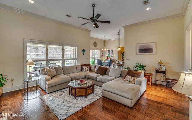 living room with ornamental molding, wood-type flooring, and visible vents